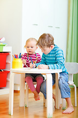 Image showing Two kids drawing together