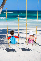 Image showing Little kids swinging