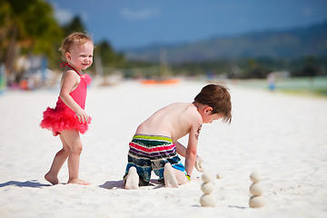 Image showing Two adorable kids standing by ocean shore