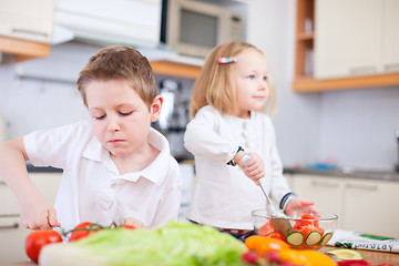 Image showing Two little kids making salad