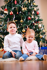 Image showing Two kids near Christmas tree