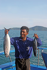 Image showing Thai fishing operator holding fish after a deep sea fishing trip