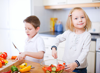 Image showing Two little kids making salad