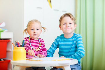 Image showing Two kids drawing with coloring pencils