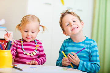 Image showing Two kids drawing with coloring pencils