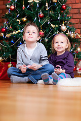 Image showing Brother and sister near Christmas tree