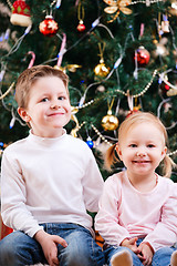 Image showing Two kids near Christmas tree