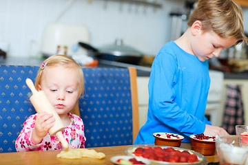 Image showing Two kids helping to bake pie 