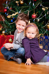 Image showing Two kids near Christmas tree