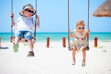 Image showing Little kids swinging