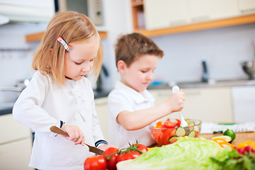 Image showing Two little kids making salad