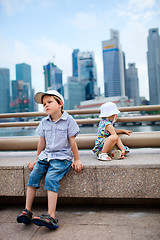 Image showing Two kids in big modern city