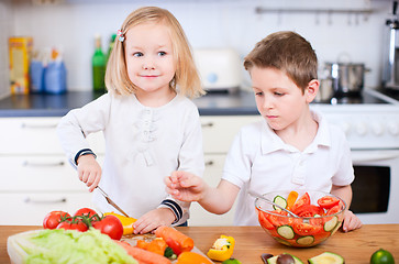 Image showing Two little kids making salad