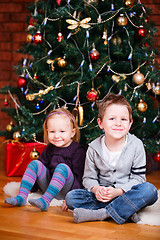 Image showing Two kids near Christmas tree