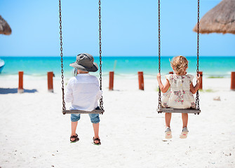 Image showing Little kids swinging