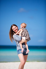 Image showing Mother with daughter walking on beach