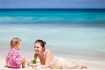 Image showing Mother and daughter playing with sand