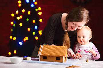 Image showing Decorating gingerbread house