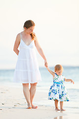 Image showing Mother and daughter on tropical beach at sunset