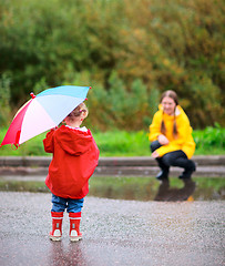Image showing Mother and daughter outdoors at rainy day