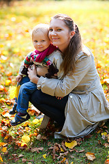 Image showing Mother and daughter outdoors at autumn day