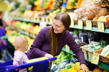 Image showing Mother and baby daughter in supermarket