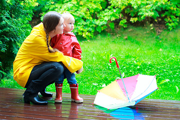 Image showing Mother and daughter outdoors at rainy day