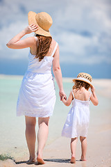 Image showing Mother and daughter walking on beach