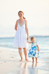 Image showing Mother and daughter on tropical beach at sunset