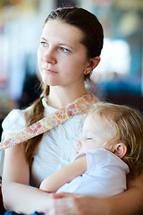 Image showing Mother holding sleeping daughter