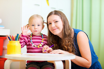 Image showing Mother and daughter drawing together