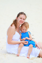 Image showing Young mother and her daughter at beach