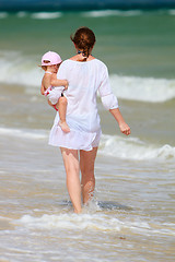 Image showing Mother and baby walking along beach