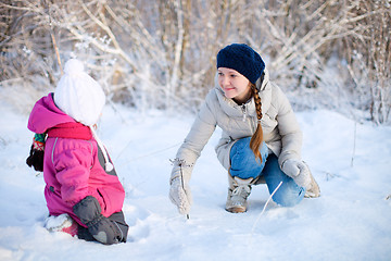 Image showing Mother and daughter outdoors at winter