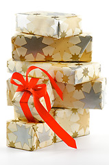 Image showing Stack of Gift Boxes and one with Red Bow