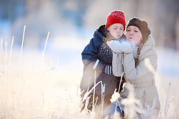 Image showing Mother and son outdoors at winter