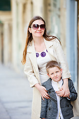 Image showing Mother and son outdoors in city