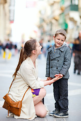 Image showing Mother and son outdoors in city