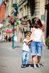 Image showing Mother and son outdoors at city