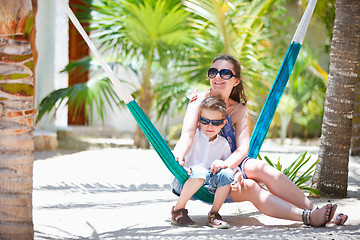 Image showing Mother and son relaxing in hammock