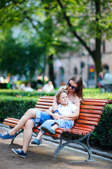 Image showing Mother and son sitting outdoors