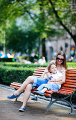 Image showing Mother and son on bench in park