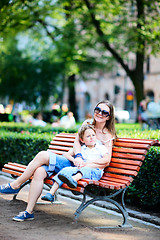 Image showing Mother and son on bench in park