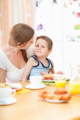 Image showing Mother and son in kitchen at morning