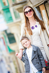 Image showing Mother and son outdoors in city