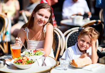 Image showing Mother and son having lunch in sidewalk restaurant