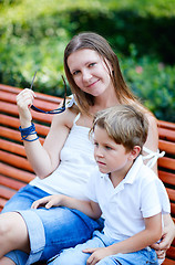 Image showing Closeup of mother and son sitting outdoors