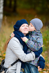 Image showing Boy kissing his mother outdoor