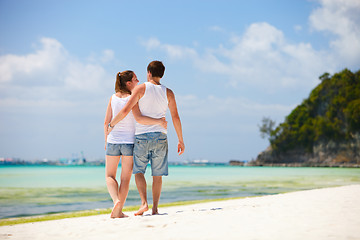 Image showing Romantic couple walking along tropical beach