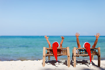 Image showing Couple in Santa hats on tropical beach